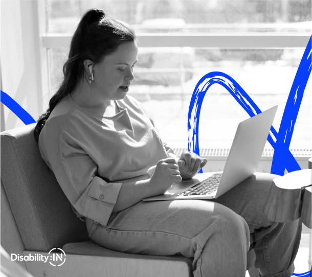 A woman wearing headsets is looking at her laptop screen