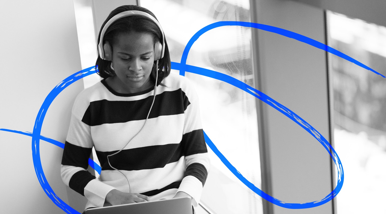 Woman with headsets working on her laptop