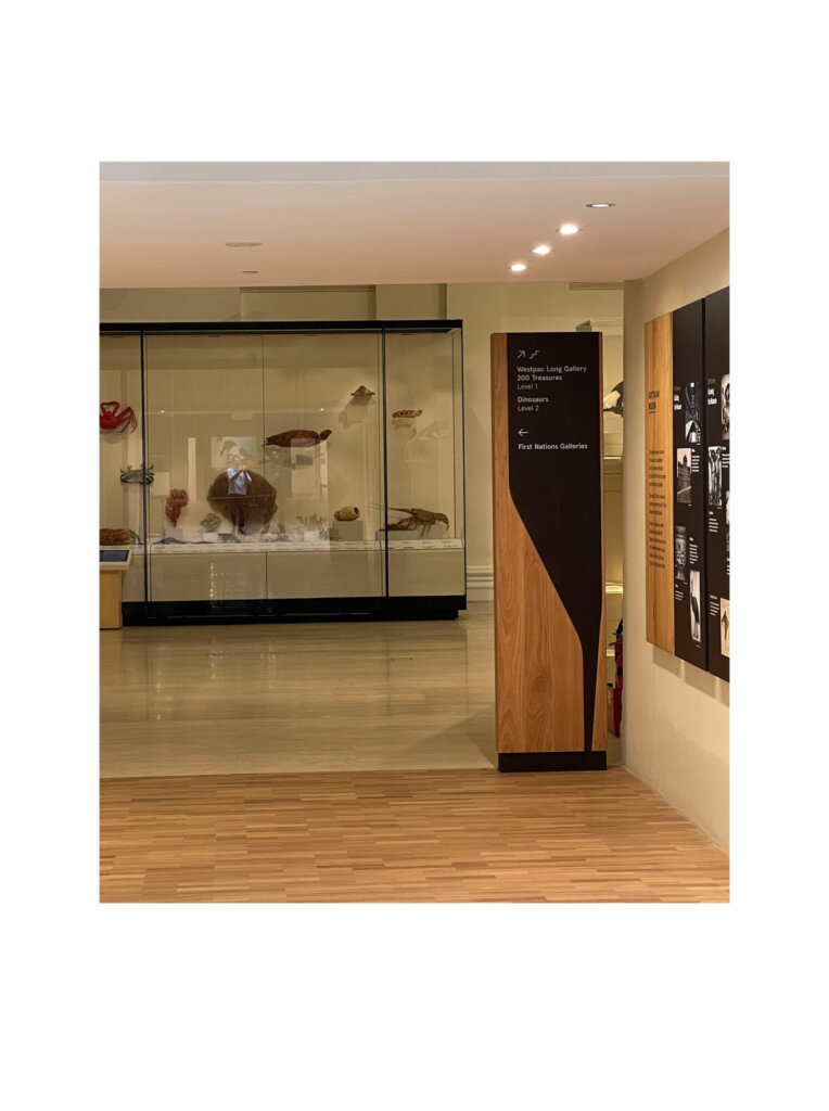 Freestanding directional signage in the museum exhibit space.