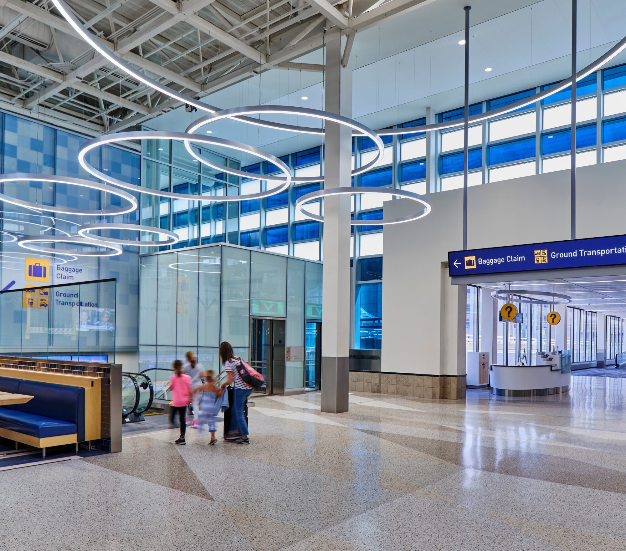 Interior photo of signage, guiding travellers to baggage claim and ground transportation.