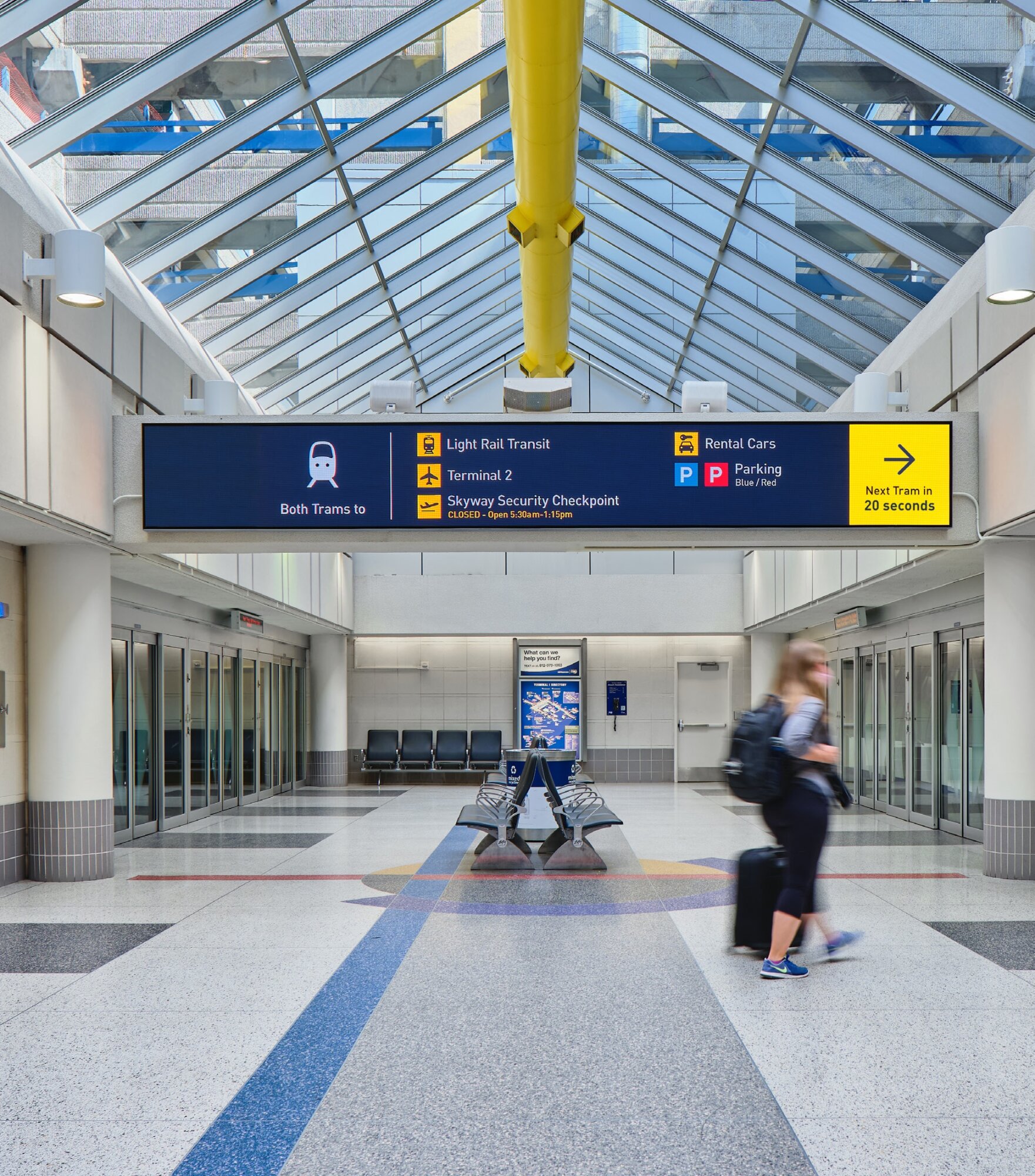Example of overhead signage guiding travellers to the tram, parking and rental cars.