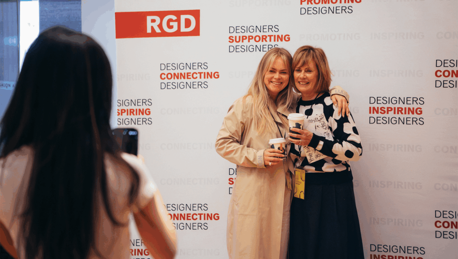 DesignThinkers attendees posing in front of the RGD Membership Booth